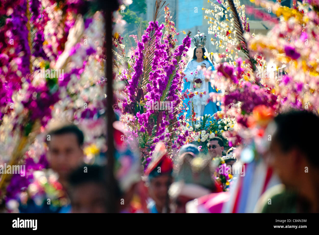 A statue of Virgin Mary is carried during the procession of the Flower & Palm Festival in Panchimalco, El Salvador. Stock Photo