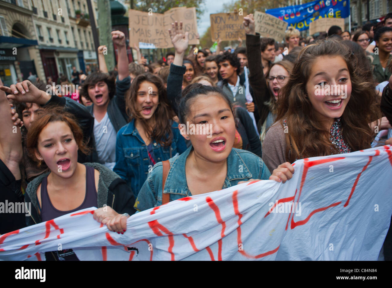 Crowds French students march to protest against government austerity measures that affects also Education. Paris, Protests, FRANCE YOUTH DEMO, young people protesting march street, budget protests Banners Stock Photo
