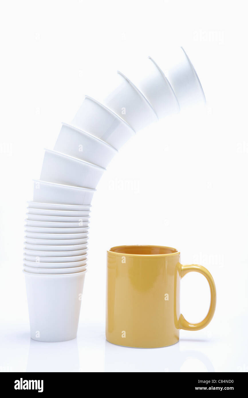 Winding pack of paper cup and yellow mug Stock Photo - Alamy