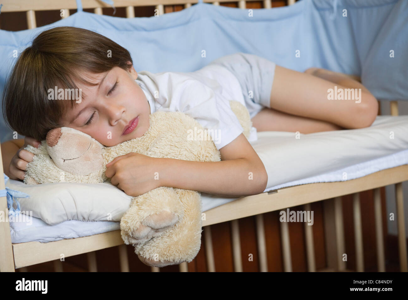 Boy sleeping in crib Stock Photo Alamy