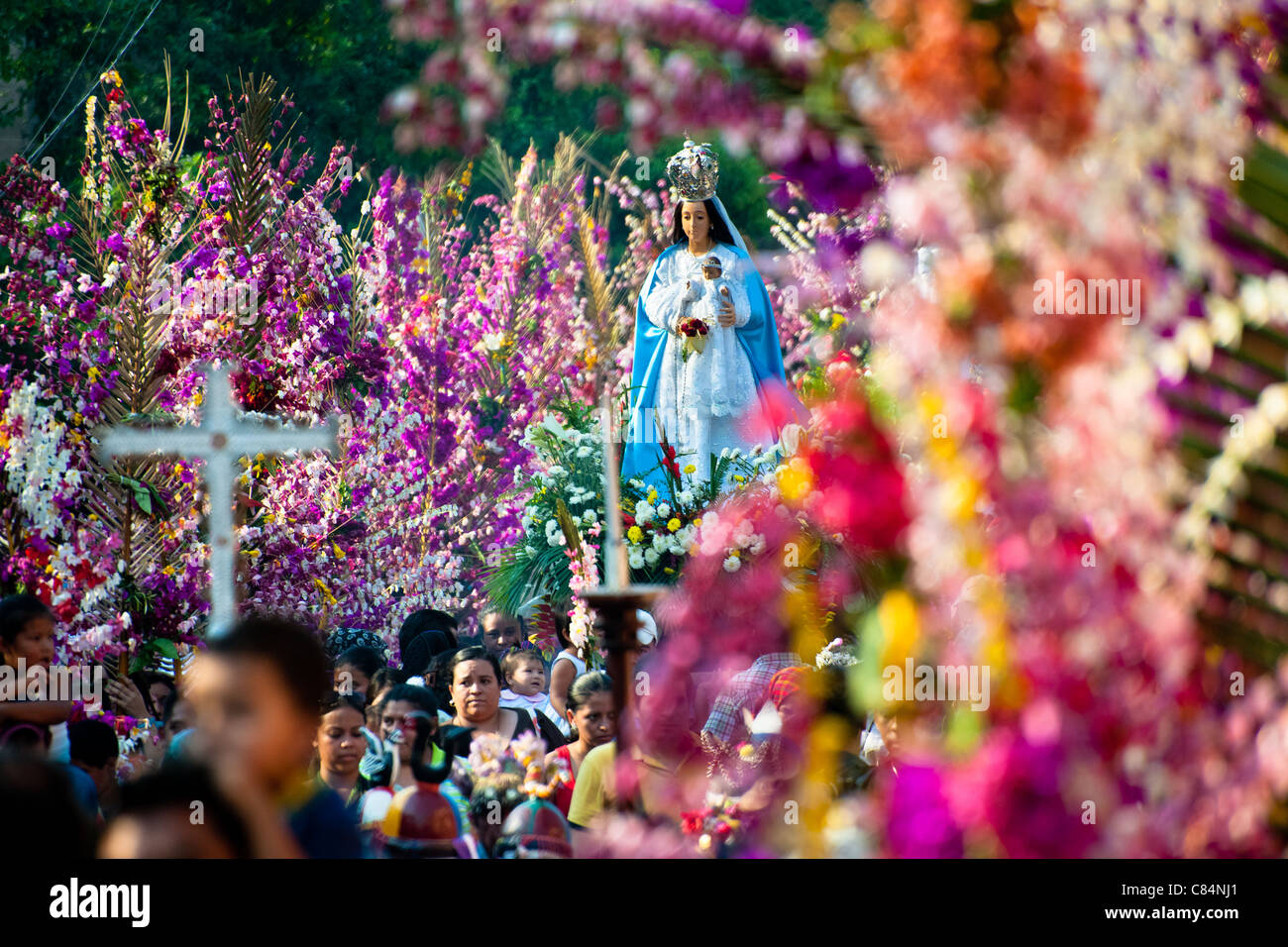 A statue of Virgin Mary is carried during the procession of the Flower & Palm Festival in Panchimalco, El Salvador. Stock Photo