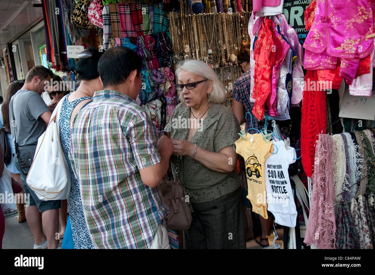 Tourists buying souvenirs in Chinatown in New York, USA Stock Photo