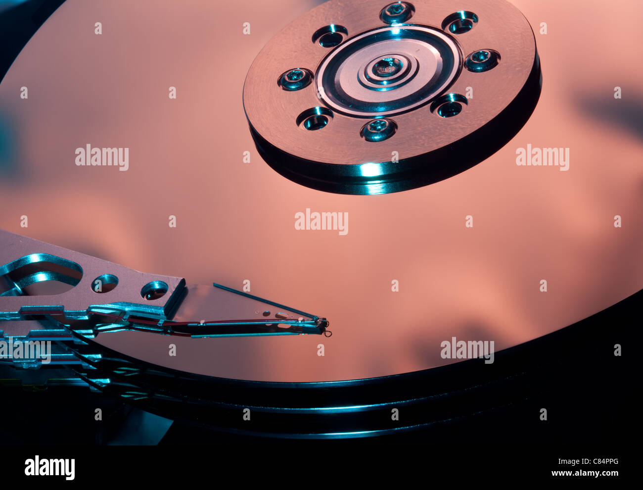 Magnetic disc inside a computer hd unit showing mirror surface of the magnetic discs and read write head Stock Photo