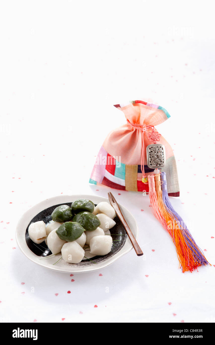 Rice cake, colorful patched lucky bag, and traditional clothes accessory Stock Photo