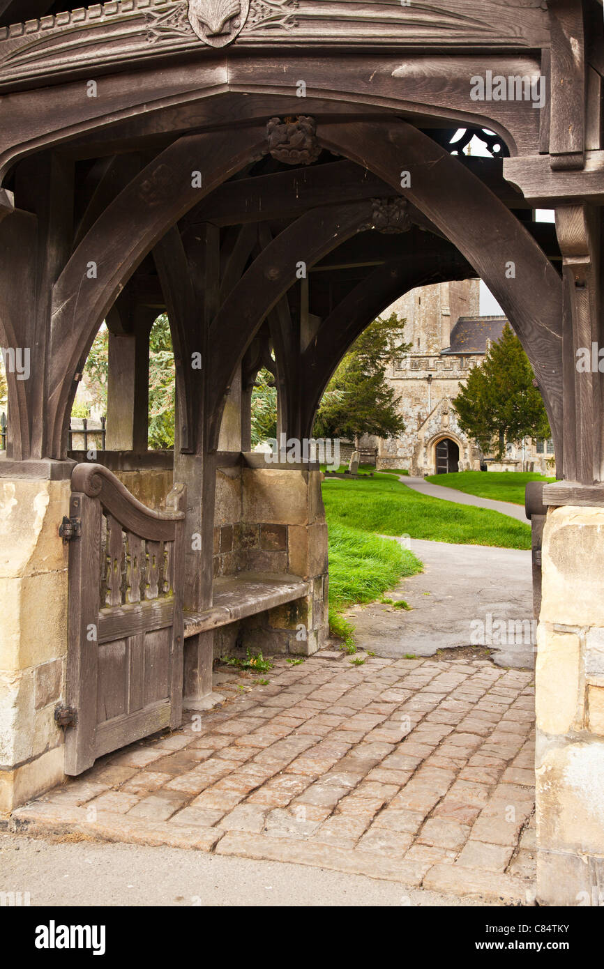 View through lych gate to churchyard and St James' church in Avebury in Wiltshire, England, UK Stock Photo