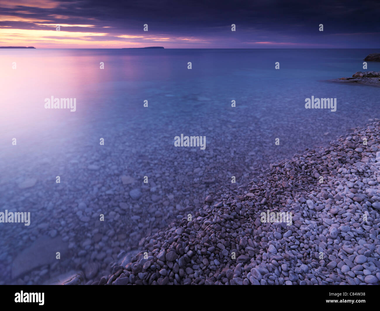 Beautiful sunset scenery of Georgian Bay pebble shore. Bruce Peninsula National Park, Ontario, Canada. Stock Photo