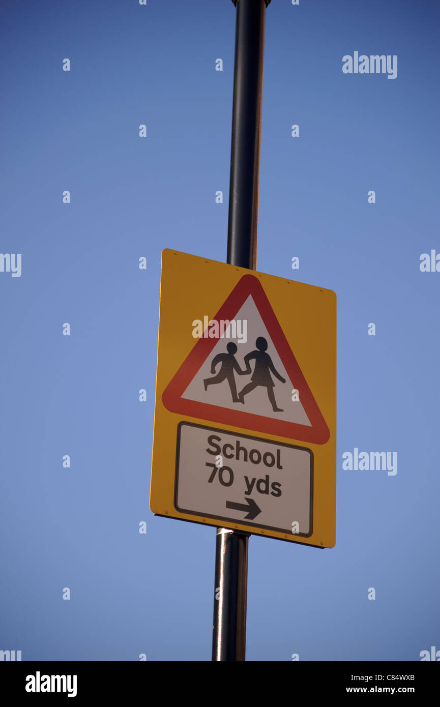Yellow warning sign for school crossing Stock Photo