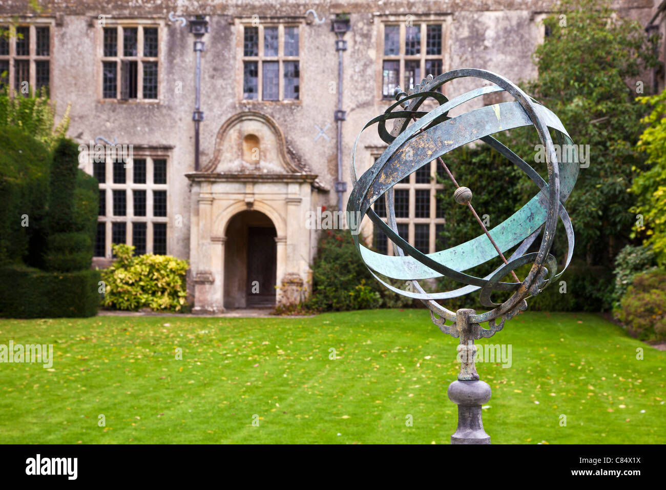 A sundial or astrolabe in the garden of a typical English country manor in Avebury in Wiltshire, England, UK Stock Photo