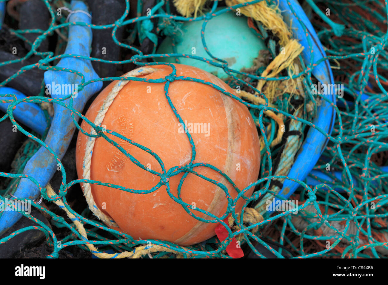 Fishing nets and buoys piled on a dock in Akaroa, New Zealand Stock Photo