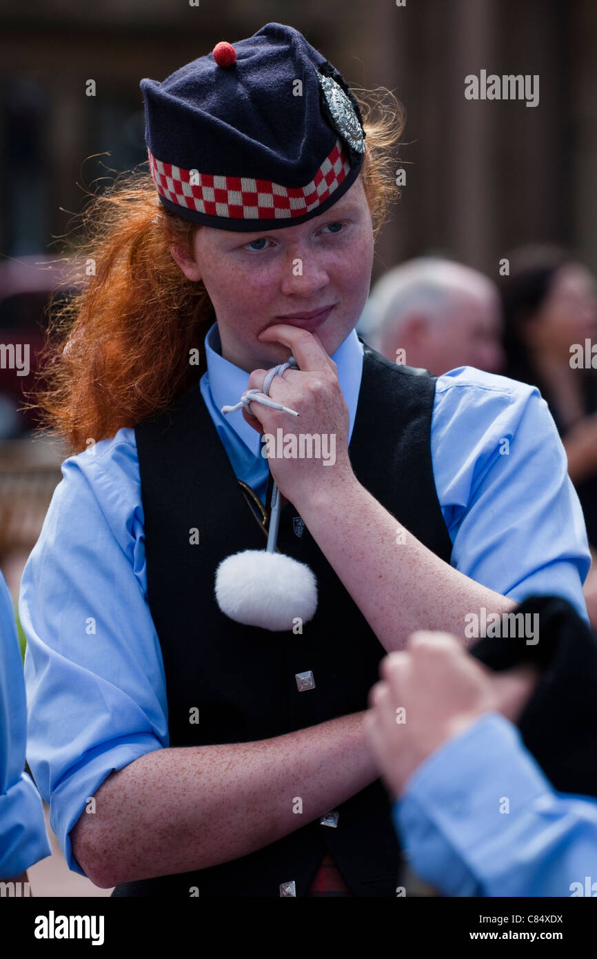 Young girl, drummer, watching the pipe bands at The Piping Festival