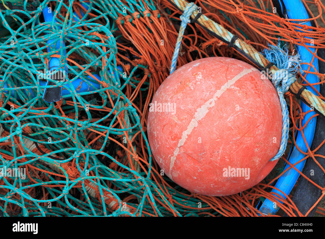 Fishing nets and buoys piled on a dock in Akaroa, New Zealand Stock Photo