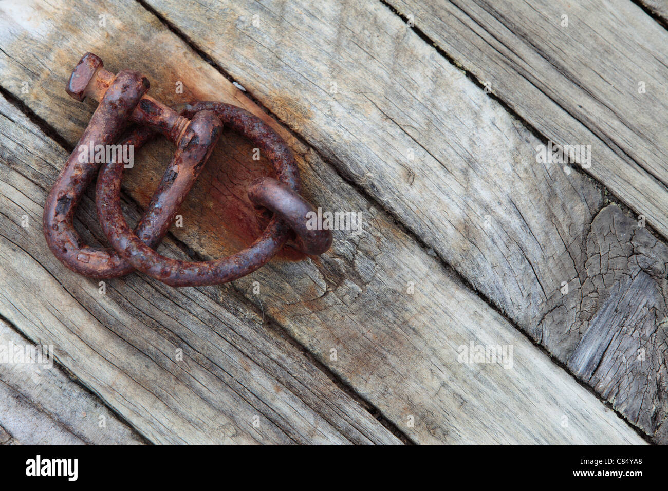 A rusty iron shackle along the dock at Akaroa, New Zealand Stock Photo