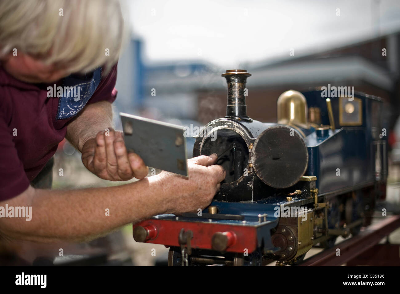 Miniature railway enthusiast tends to his steam engine at Canvey island, Miniature railway club, Essex, UK Stock Photo