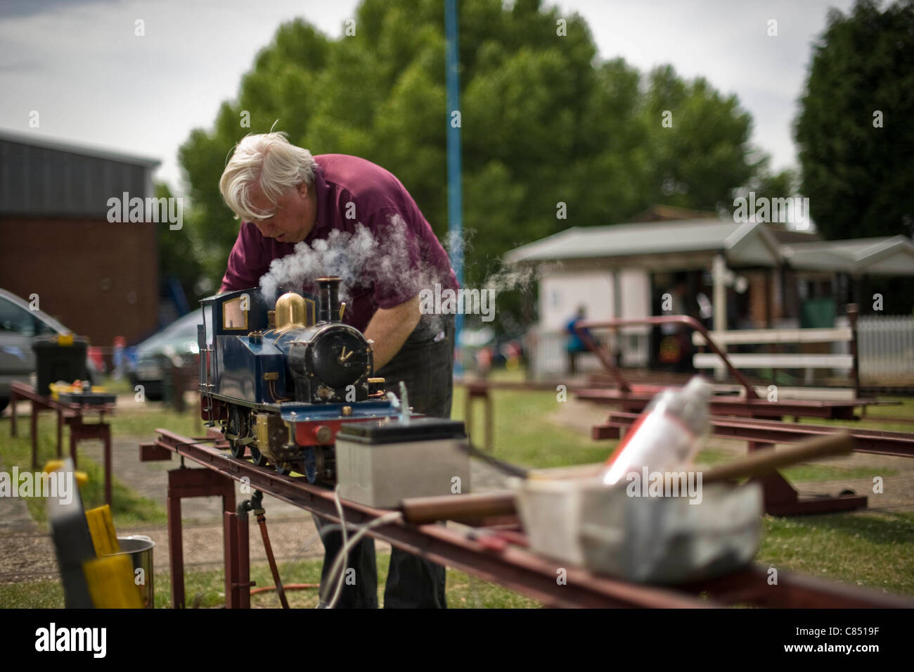 Miniature railway enthusiast tends to his steam engine at Canvey island, Miniature railway club, Essex, UK Stock Photo