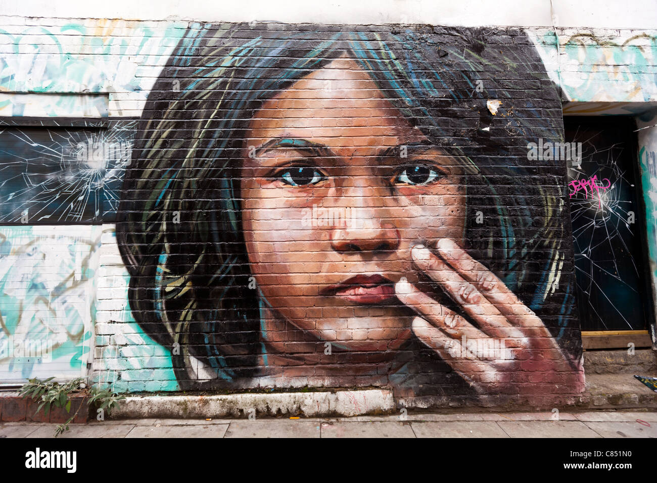 Street art by Cosmo Sarson, Hanbury street London, England.  ‘The image is of a Bangladeshi girl surrounded by decay' Stock Photo