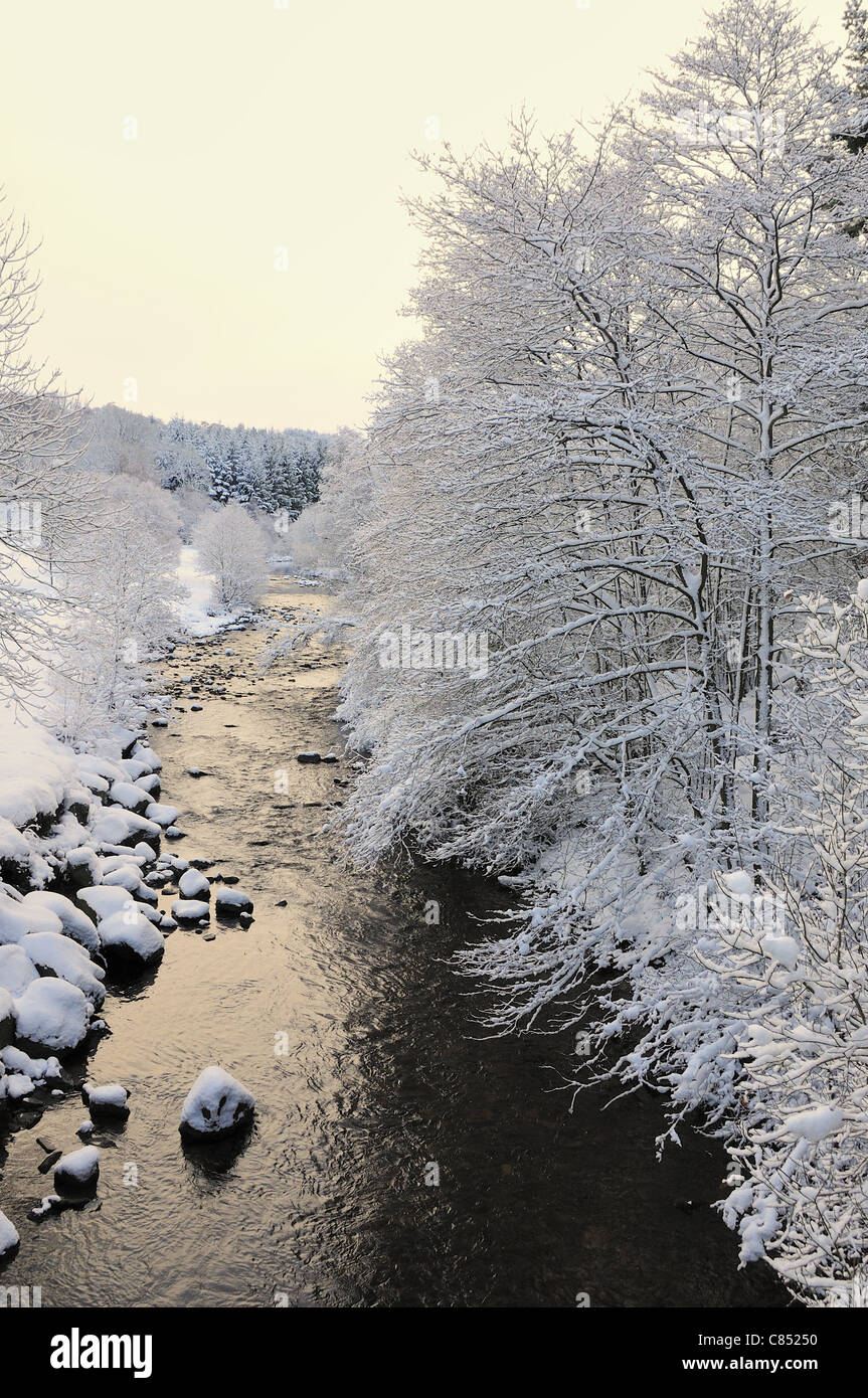 river landscape in winter with snow covered trees and boulders Stock ...