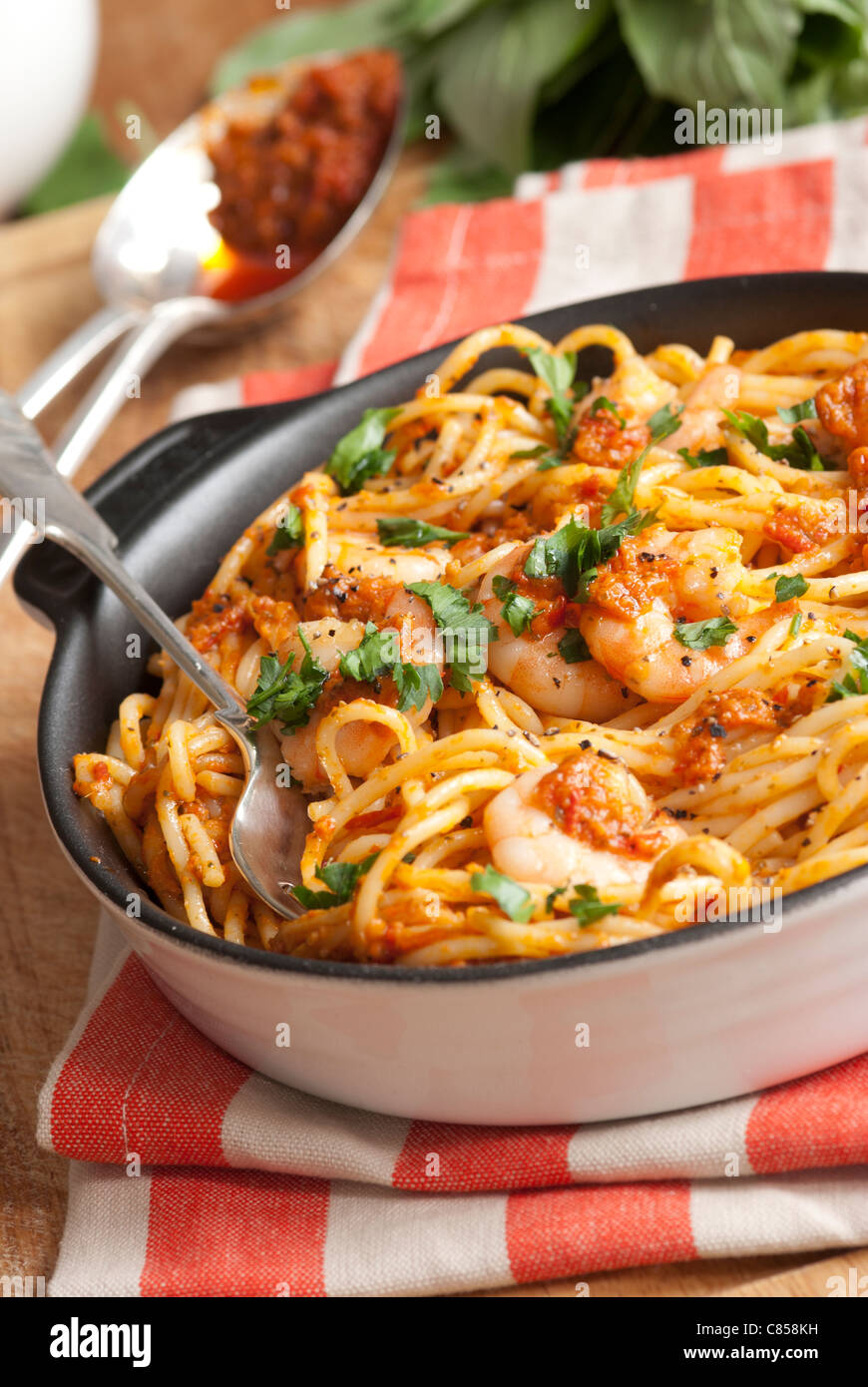 Spaghetti with king prawns and chilli pesto sauce Stock Photo Alamy