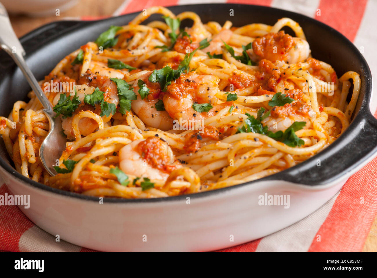 Spaghetti with king prawns and chilli pesto sauce Stock Photo Alamy