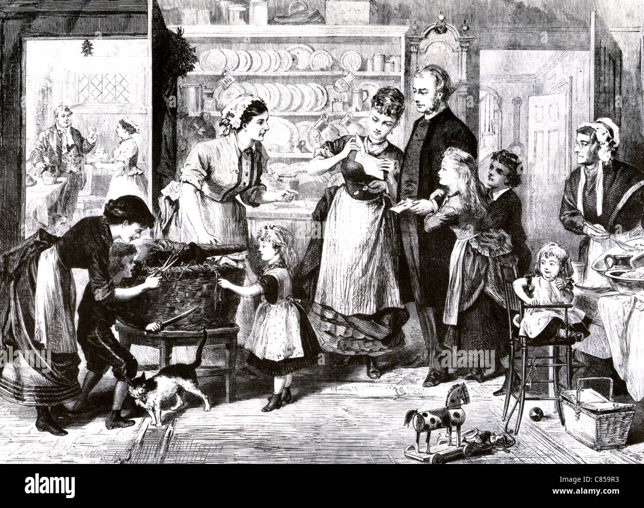 VICTORIAN CHRISTMAS  Engraving showing a clergyman's family unpacking a Christmas hamper Stock Photo