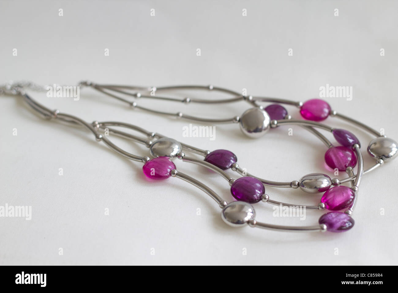 A pretty purple and silver necklace with amethyst colors and photographed in natural light Stock Photo