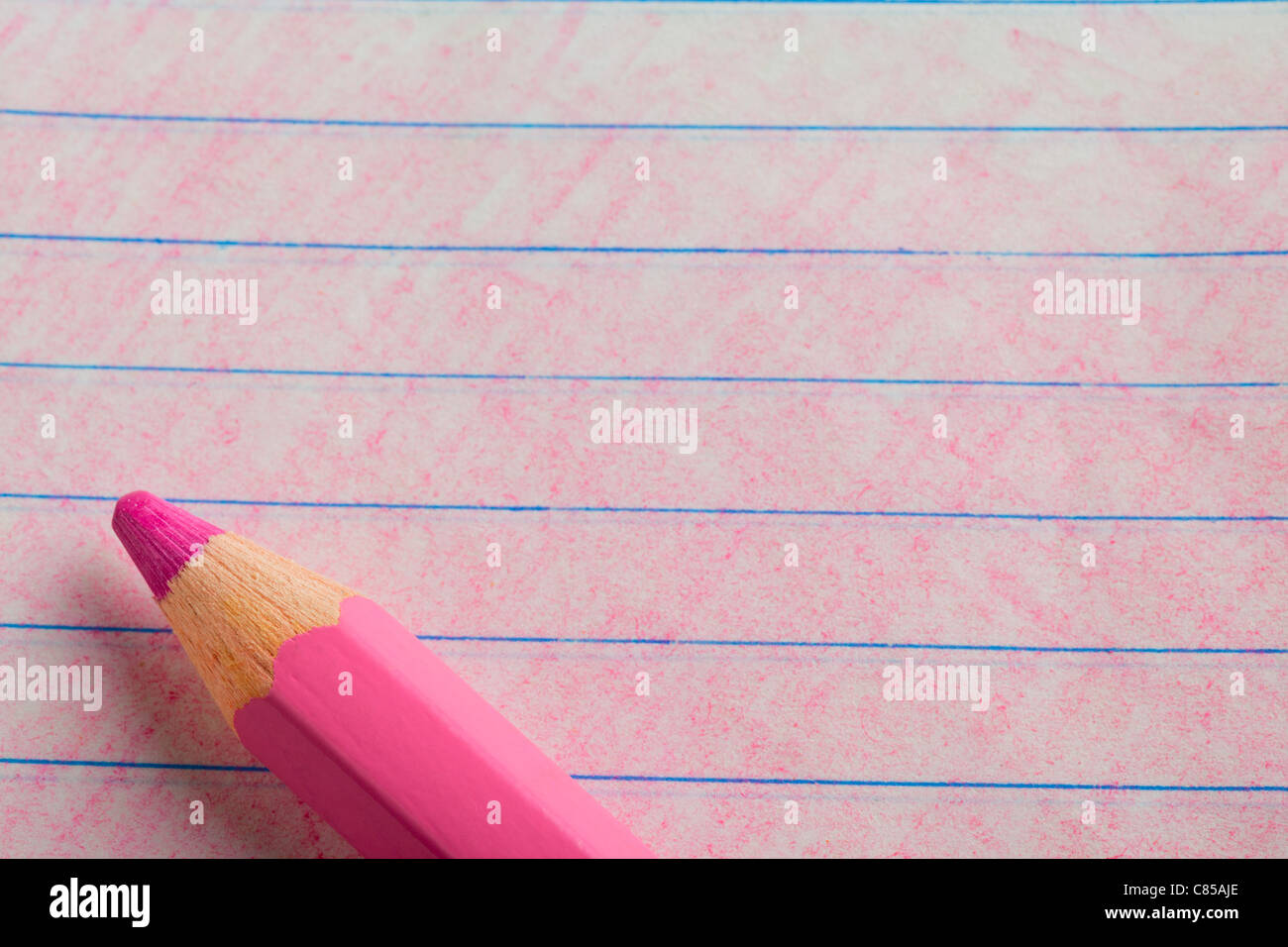 Pink color pencil with coloring on a piece of writing paper Stock Photo