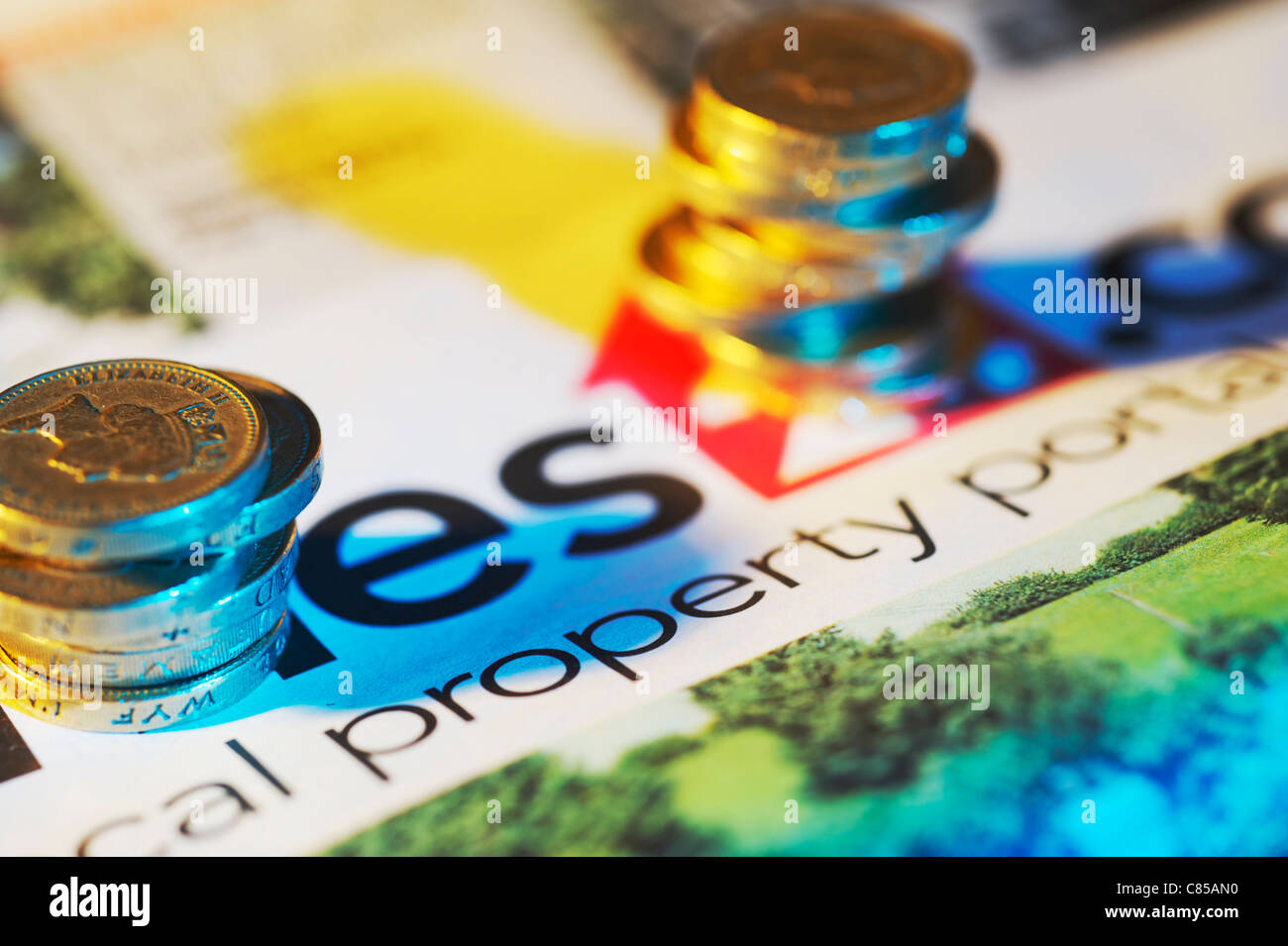 UK Pound coins stacked on property paper Stock Photo