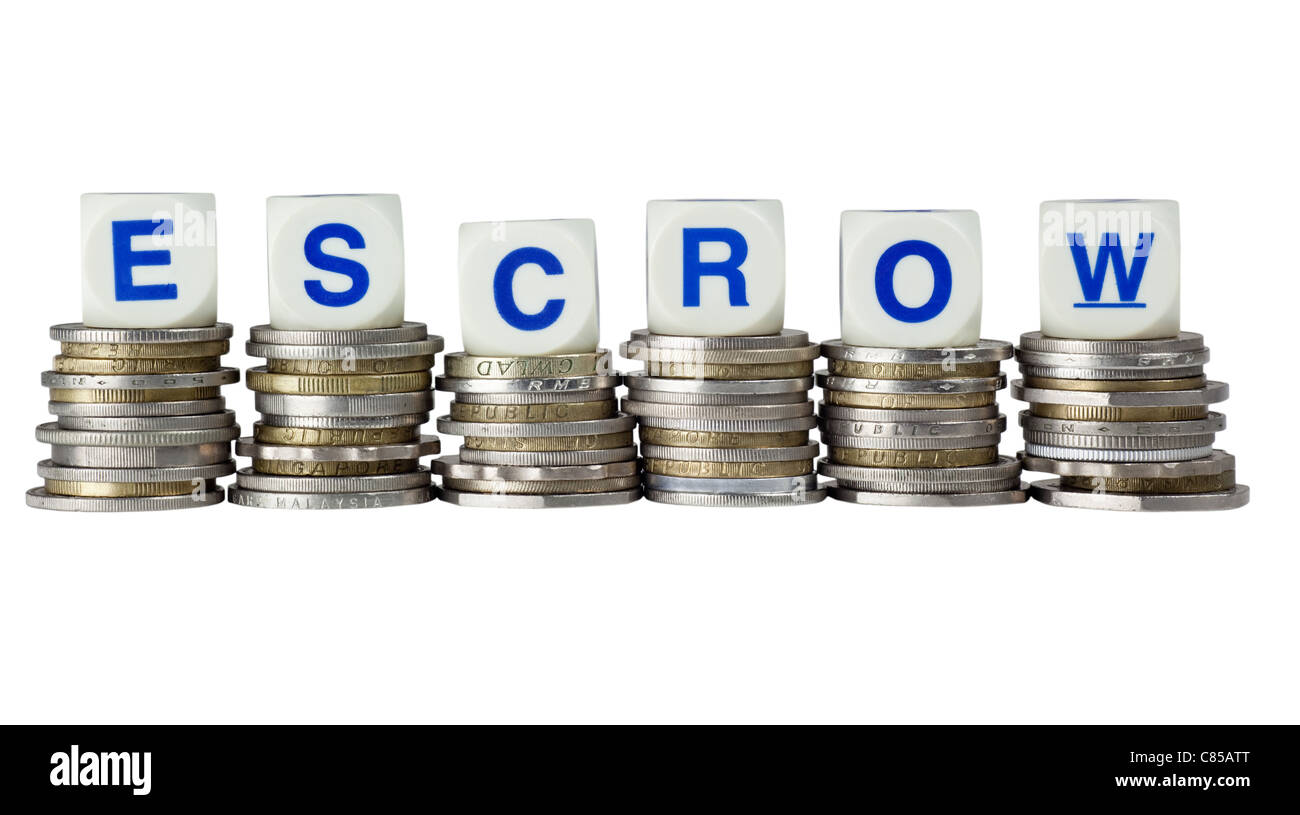 Stacks of coins with the word ESCROW isolated on white background Stock Photo