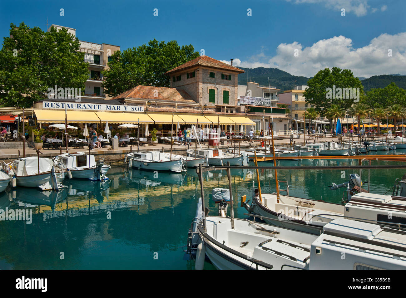 Port Soller harbour with fishing boats and waterside tapas restaurant  and café  Palma de Mallorca Spain Stock Photo