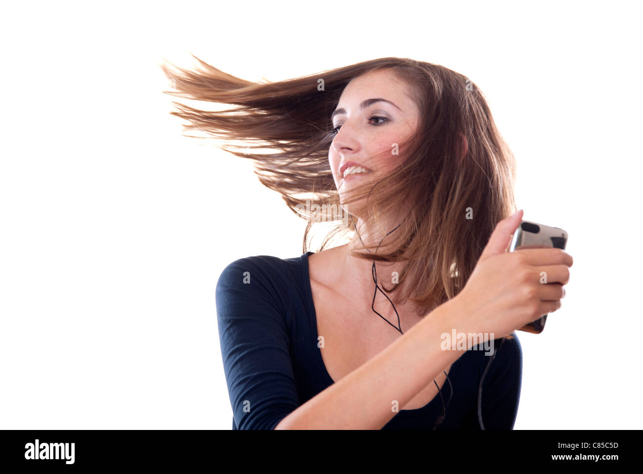 young woman dancing to music with hair swishing Stock Photo