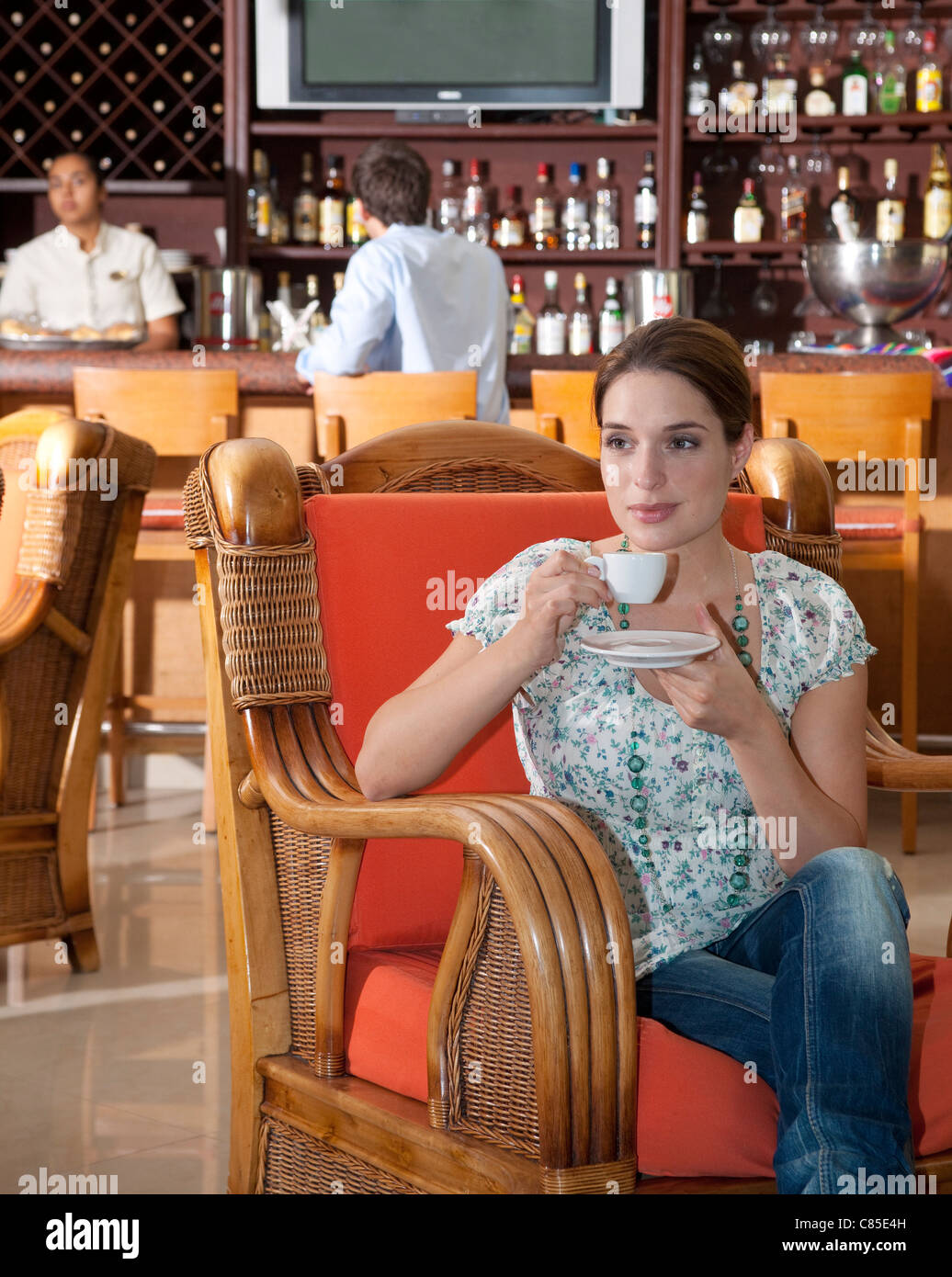 Woman Drinking Coffee in Restaurant Stock Photo