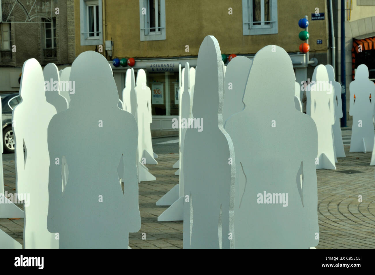 Mayenne city, installation on downtown of abstract female figures to raise awareness about violence against women. Stock Photo