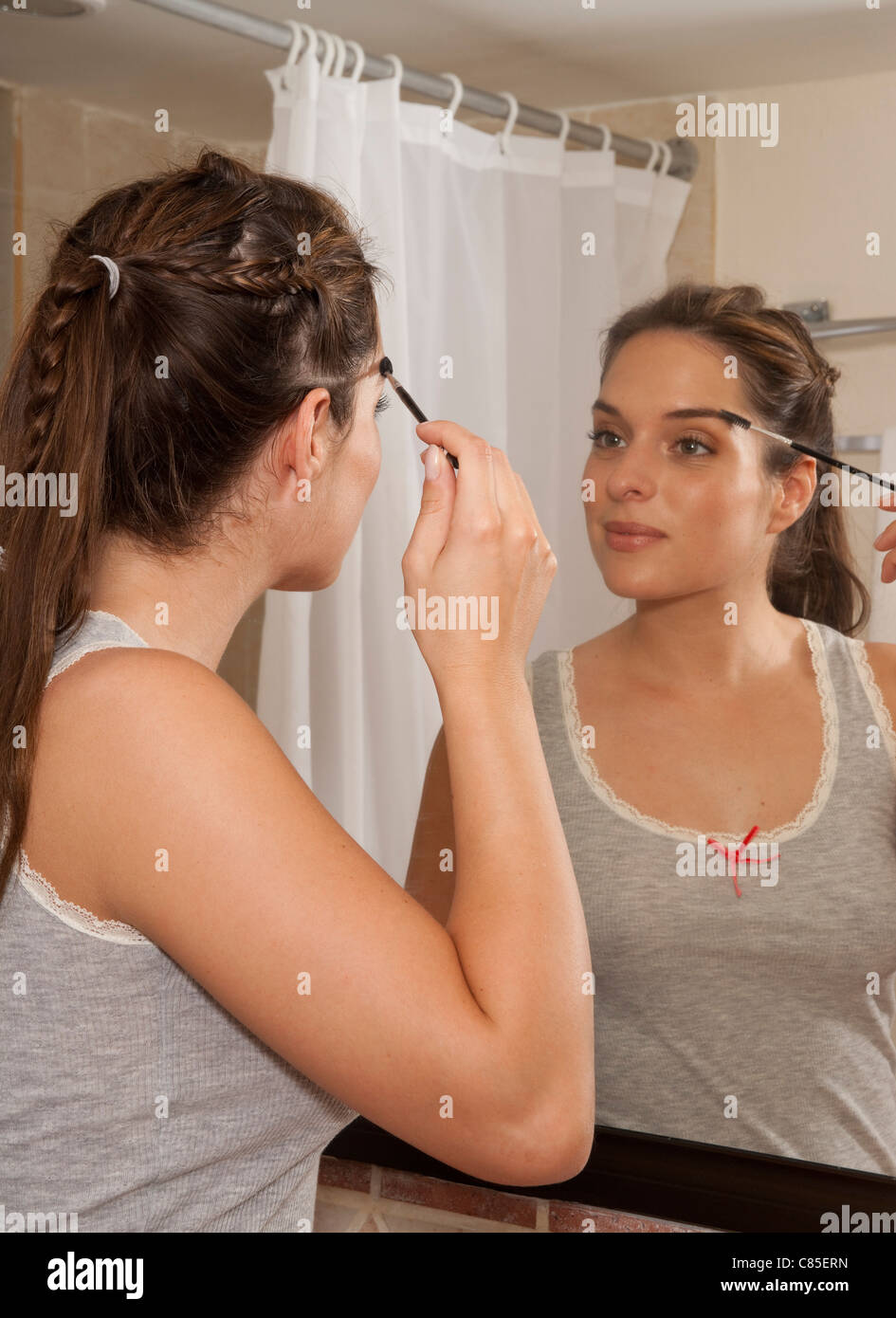 Woman Applying Make-up in Bathroom, Reef Playacar Resort and Spa, Playa del Carmen, Mexico Stock Photo