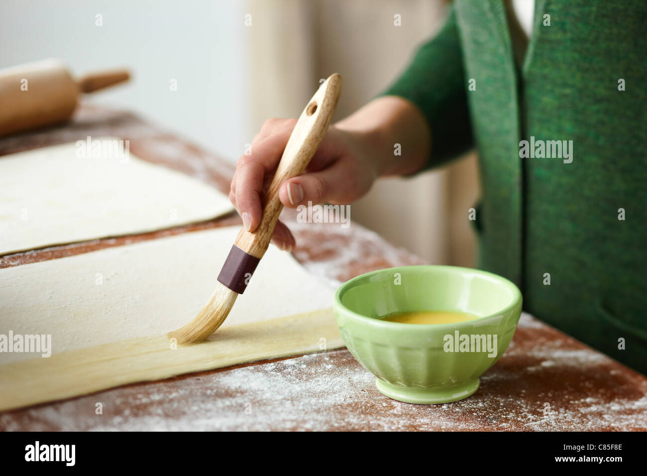 Woman Brushing Egg onto Pastry Stock Photo Alamy