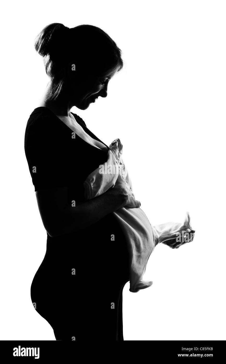 beautiful caucasian pregnant woman baby clothes in silhouette on studio isolated white background Stock Photo