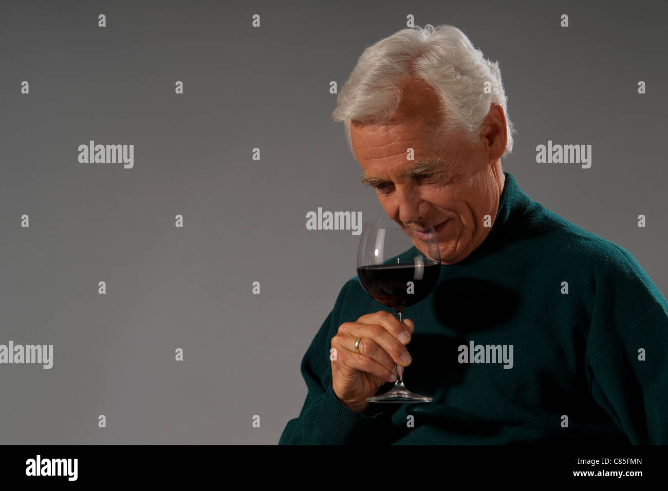older man smelling red wine Stock Photo - Alamy