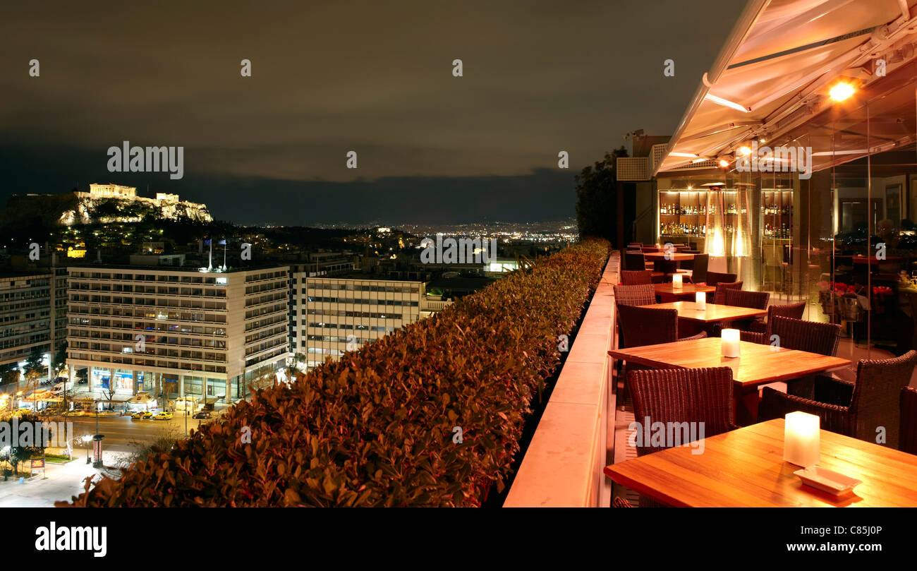 bar overlooking Acropolis at night, Athens, Greece Stock Photo