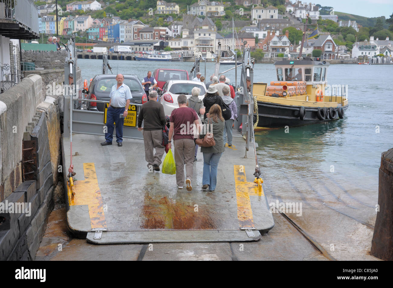 Foot passengers board the Lower Ferry to cross the River Dart from Dartmouth to Kingswear. Stock Photo