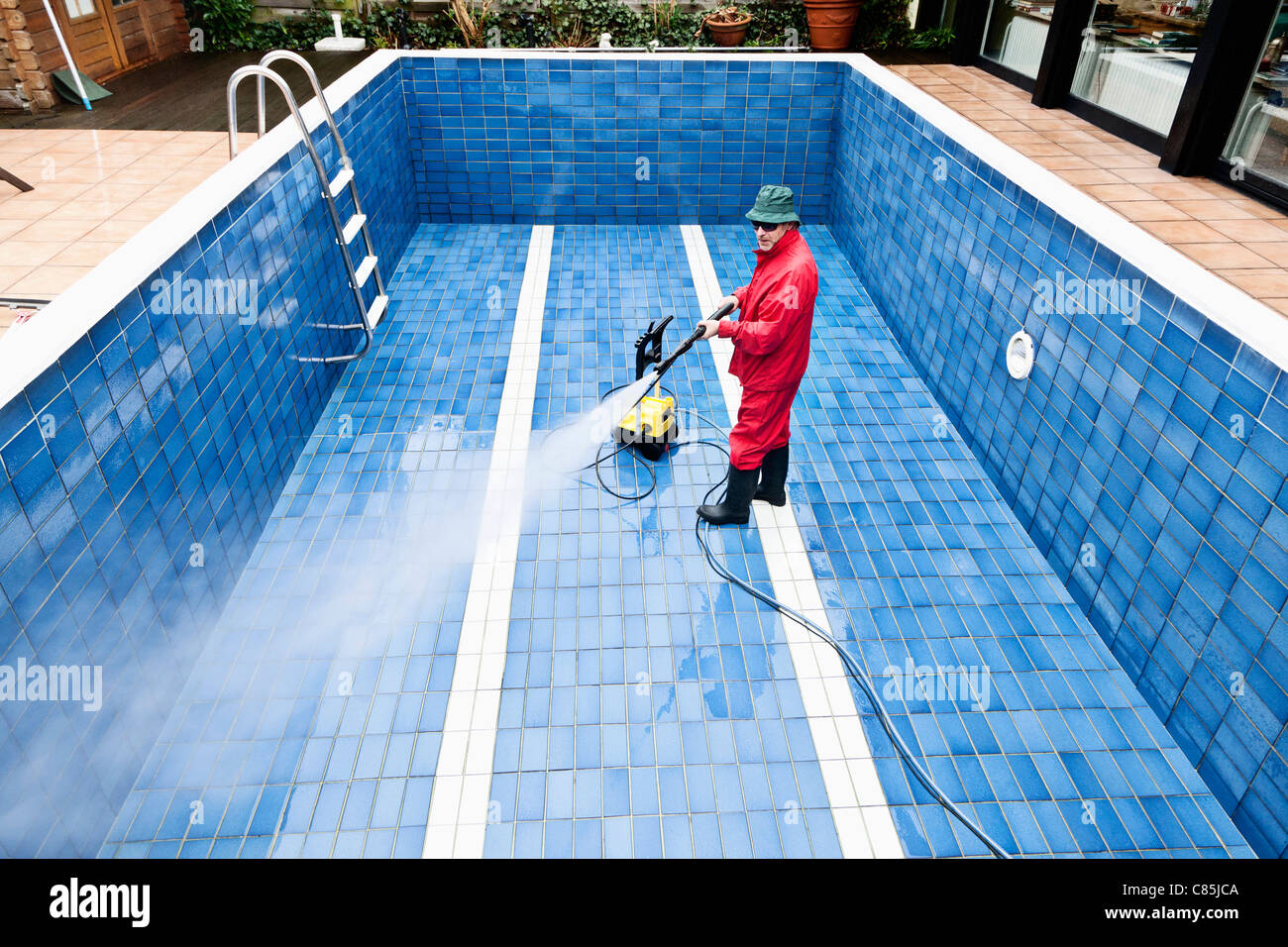 Man Cleaning Swimming Pool, Germany Stock Photo