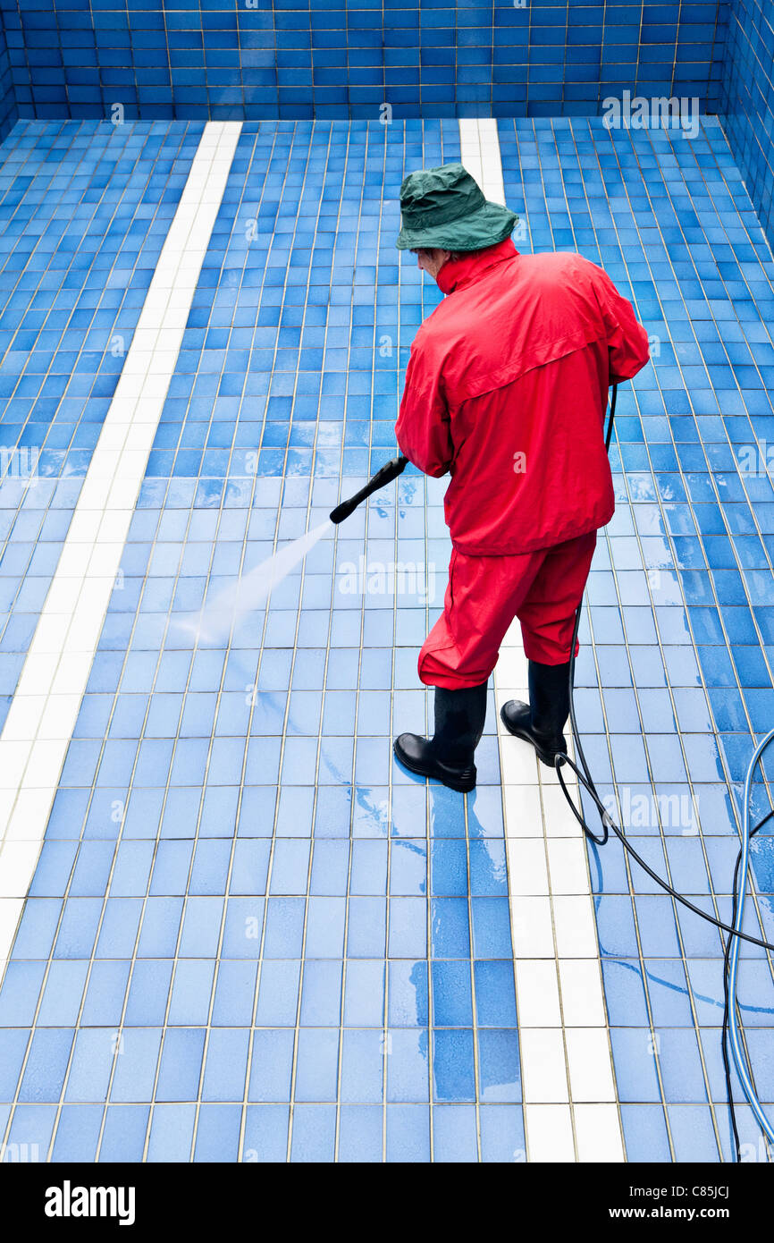 Man Cleaning Swimming Pool, Germany Stock Photo