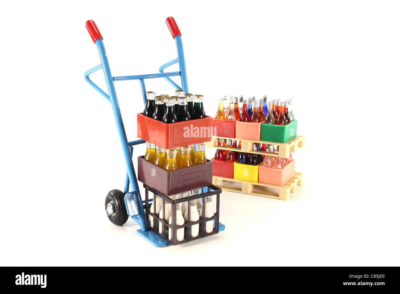 sack truck with cola, lemonade, milk and beverages stacked on euro pallets in the background Stock Photo