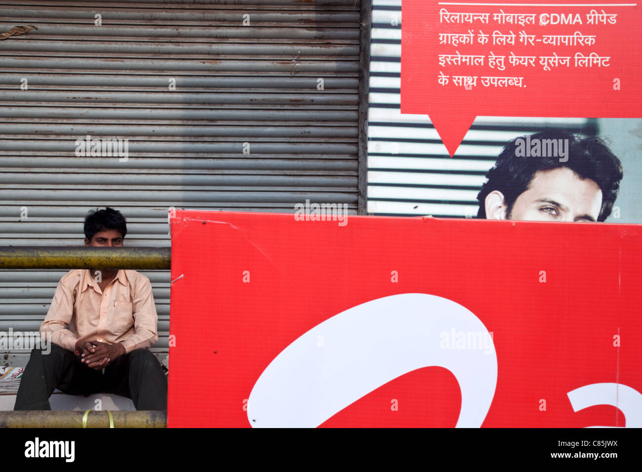 The AIRTEL mobile phone company advertising with a man in the background in the city centre of Patna, Bihar state, India. Stock Photo