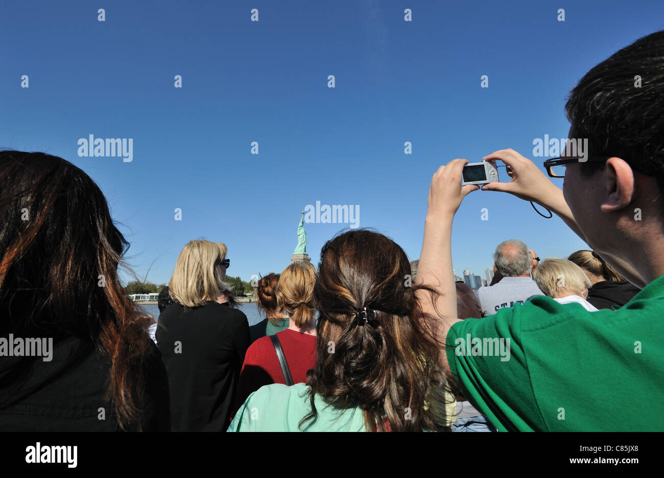Tourists aboard a Statue Cruises ferry approach the Statue of LIberty