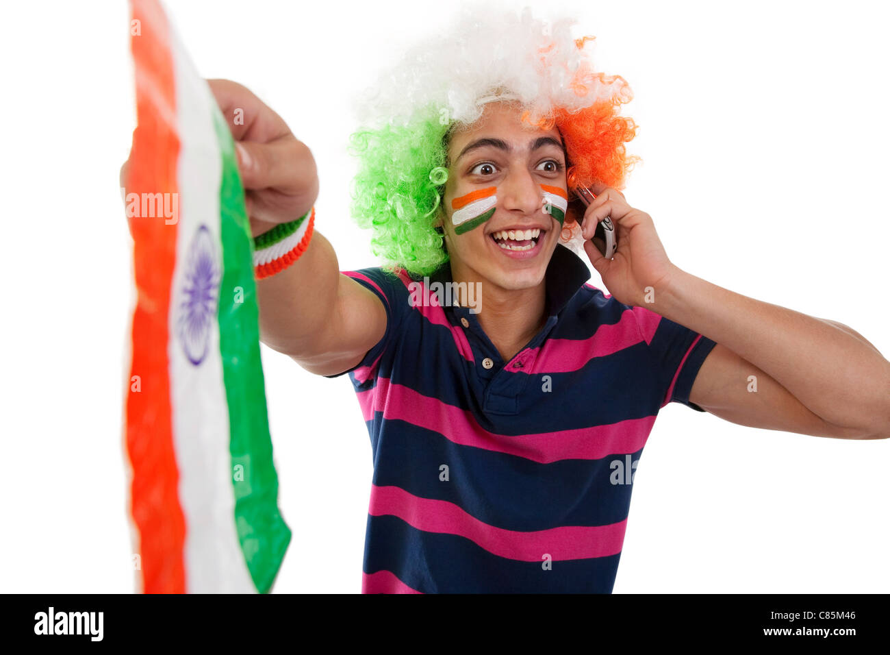 Boy talking on a phone and cheering Stock Photo