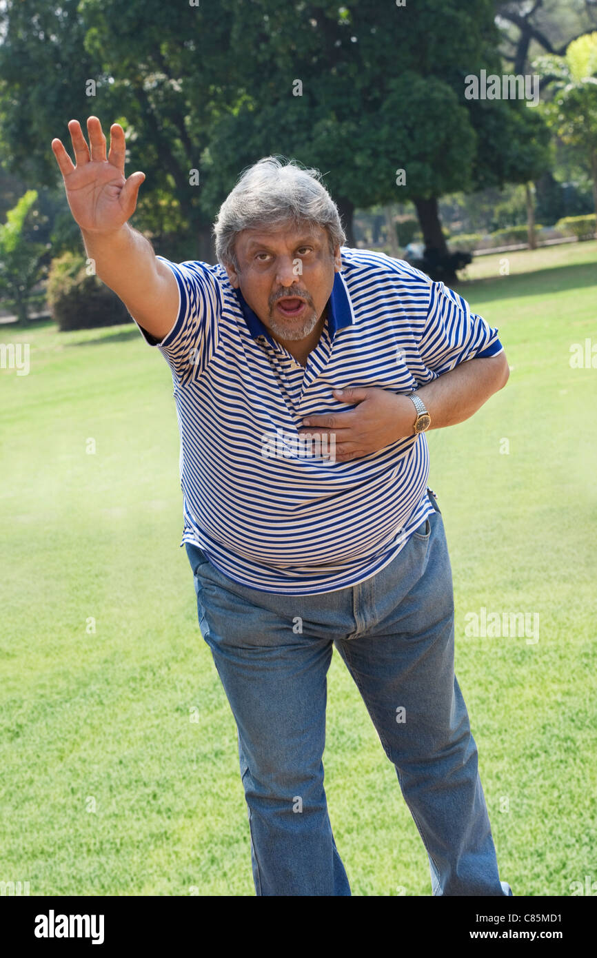 Older man out of breath signalling to stop Stock Photo