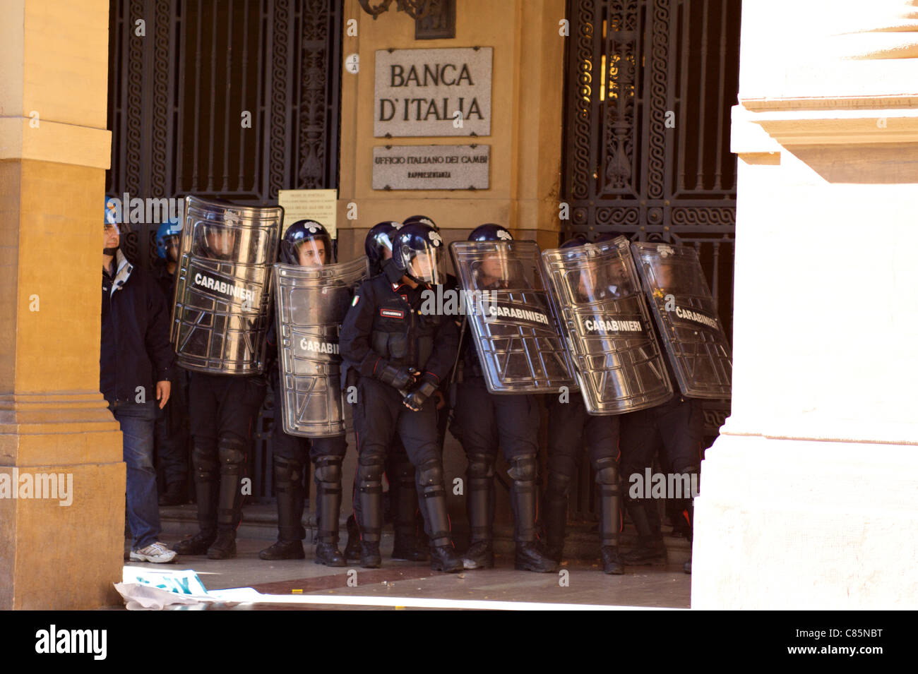 Student in protest against the crisis in Bologna (IT). police wall to defend the entrance of the Bank of Italy against protest Stock Photo