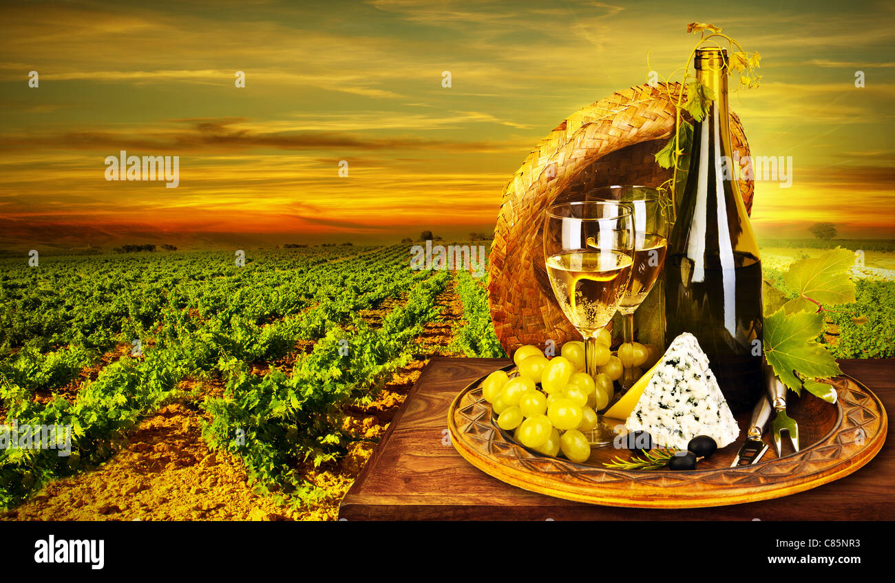 Wine and cheese romantic dinner outdoor, table for two with vineyard