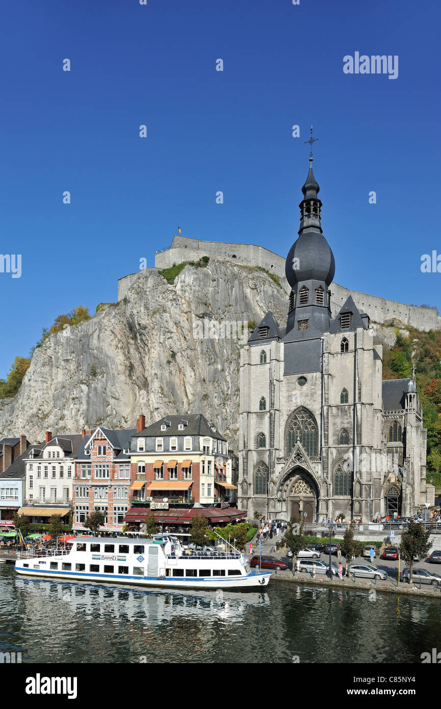 Tourists on pleasure boat, citadel and the Collegiate Church of Notre-Dame along the river Meuse at Dinant, Belgium Stock Photo