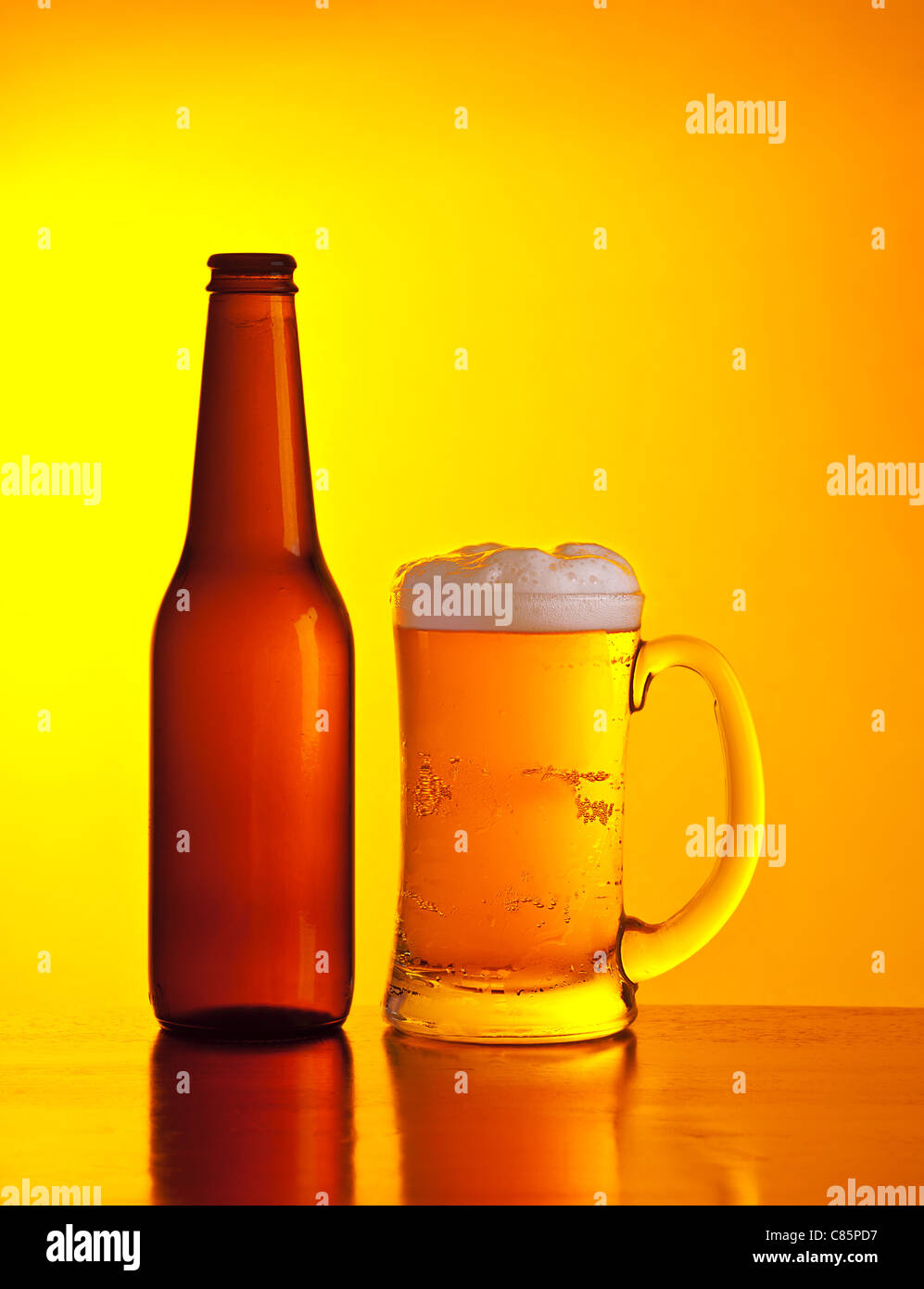 Glass of cold beer drink isolated on yellow warm background, festival