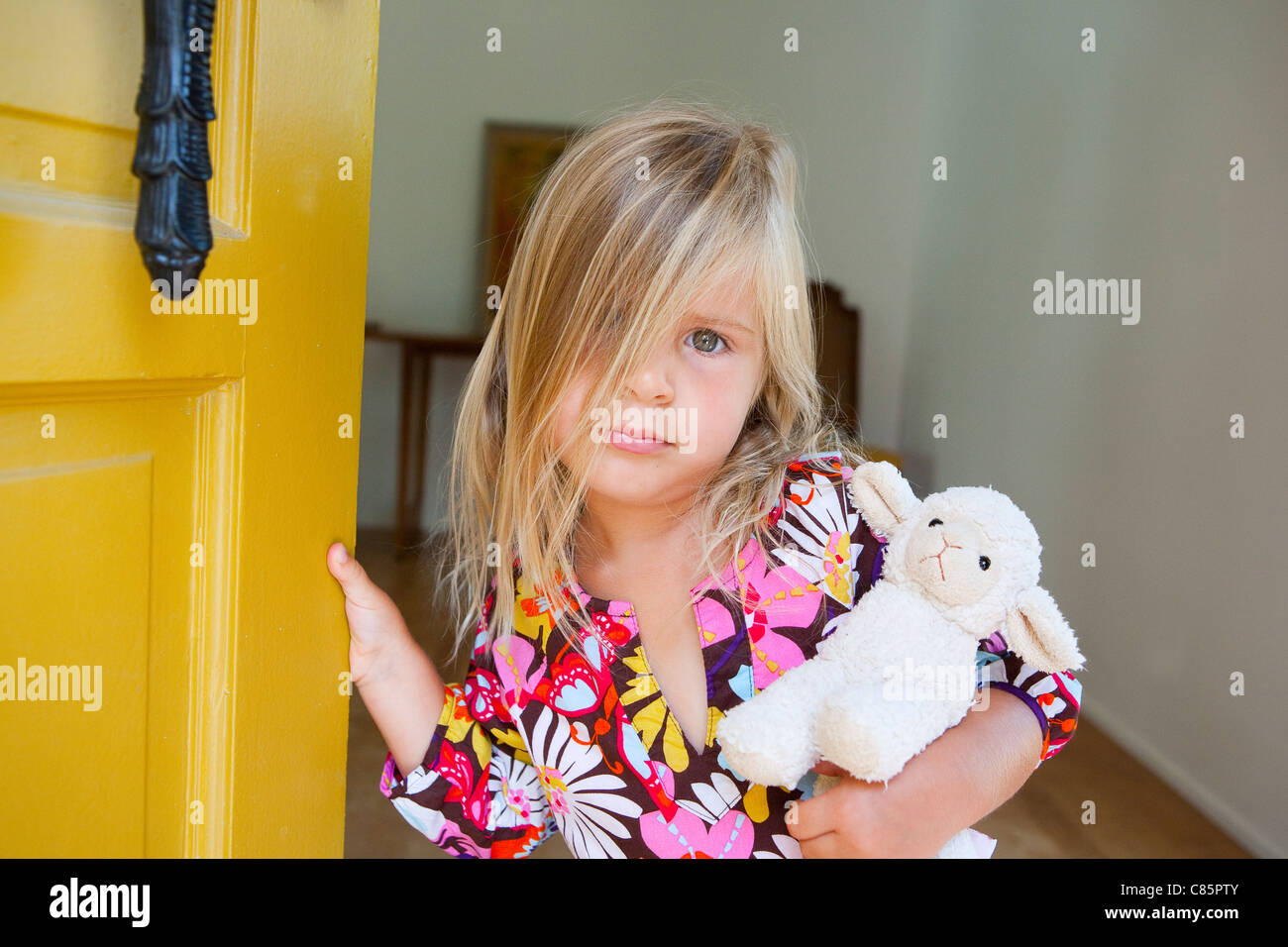 Little girl holding stuffed lamb Stock Photo - Alamy