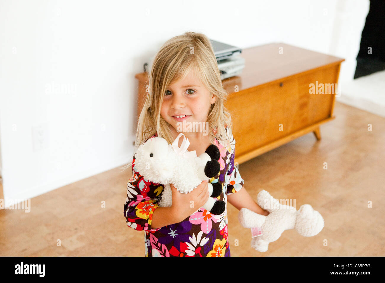 Little girl with stuffed lambs Stock Photo